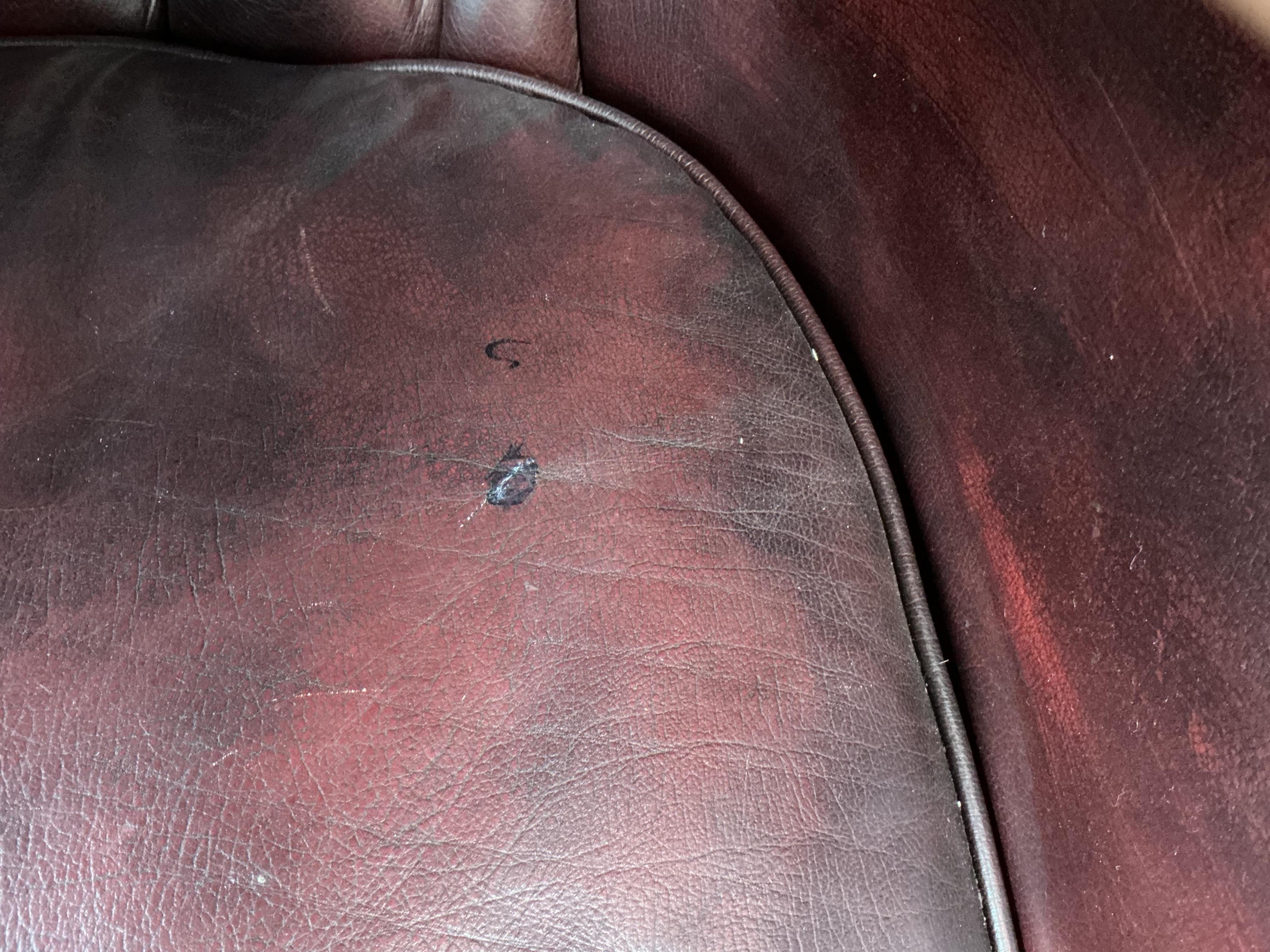 A reproduction buttoned burgundy leather hall porter's chair, width 88cm, depth 64cm, height 176cm